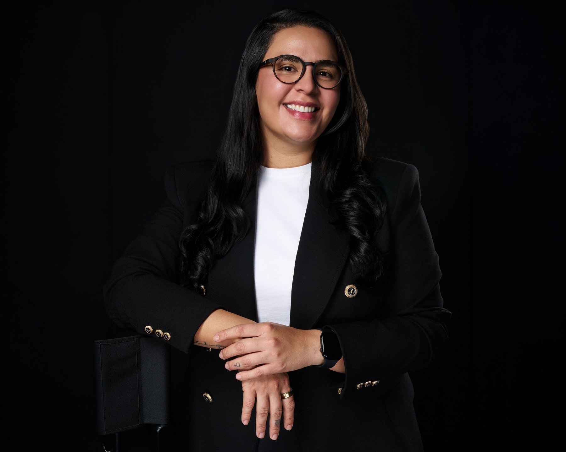 Editorial portrait on a dark backdrop